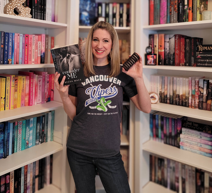 a woman holding a hair brush in front of a bookshelf