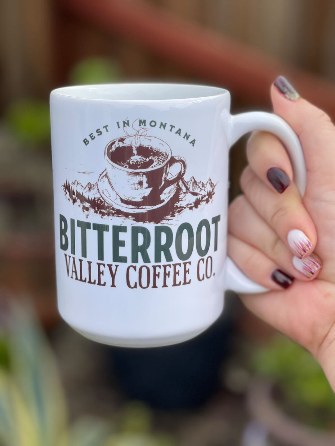 a woman holding a coffee mug in her hand