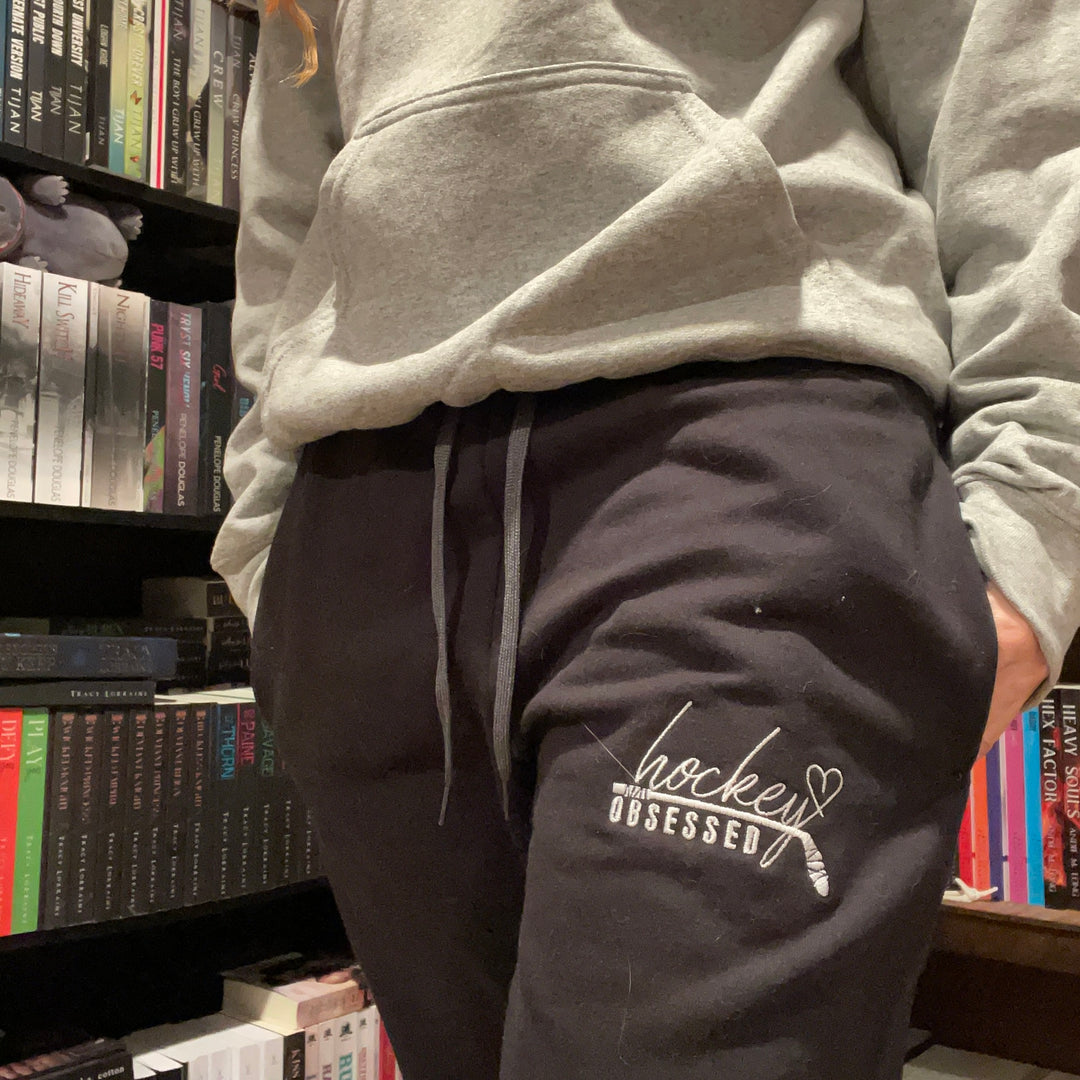 a person standing in front of a book shelf