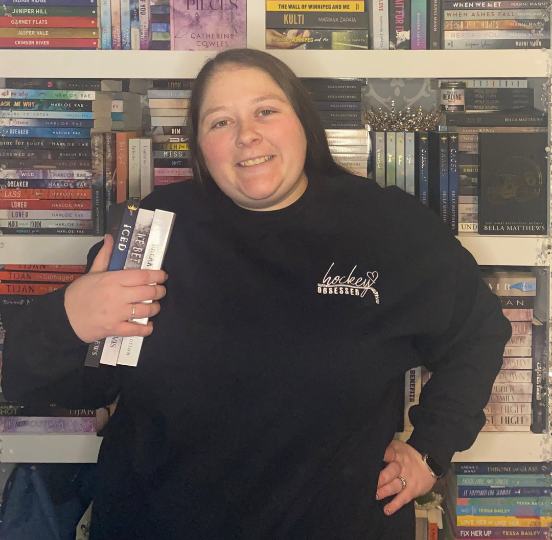 a woman standing in front of a book shelf