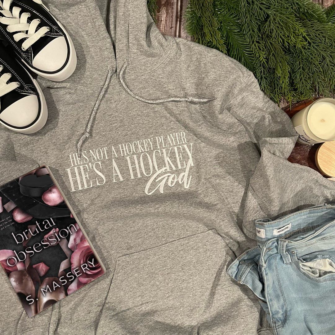 a pair of sneakers, a book, and a pair of jeans lay on a
