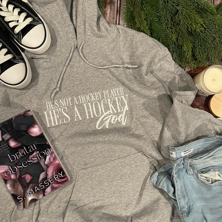 a pair of sneakers, a book, and a pair of jeans lay on a