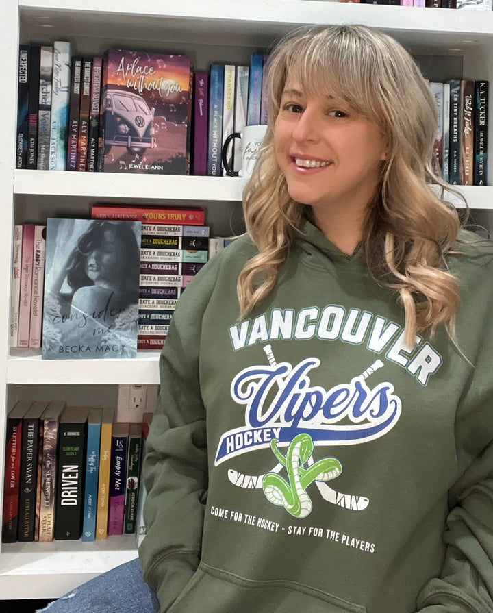 a woman sitting in front of a book shelf