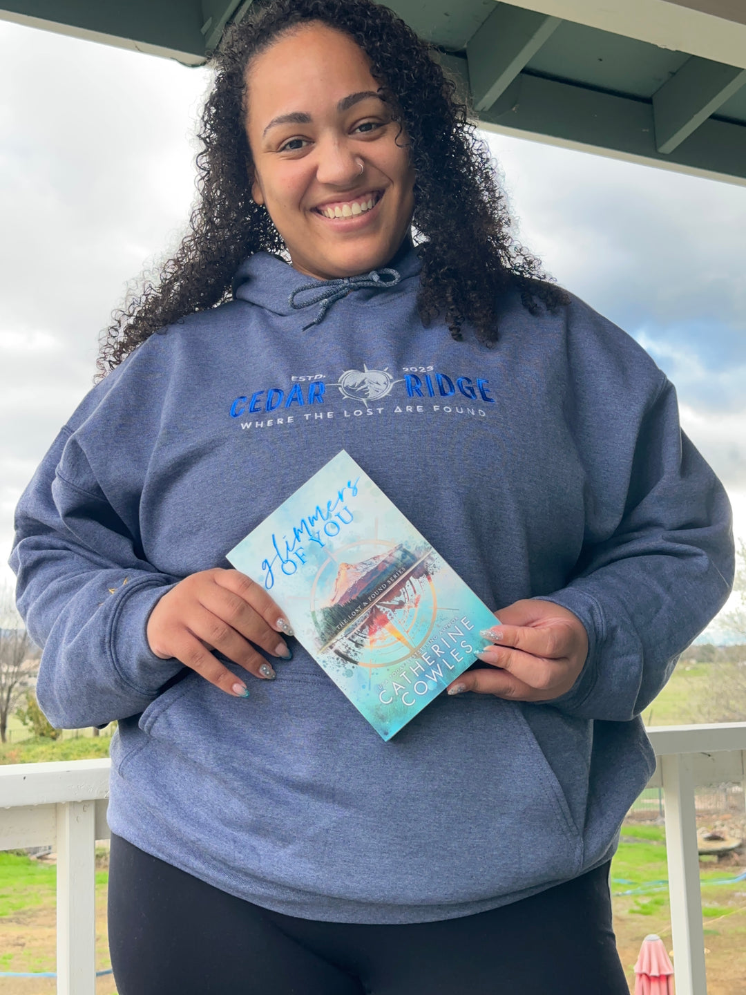 a woman in a blue shirt holding a book