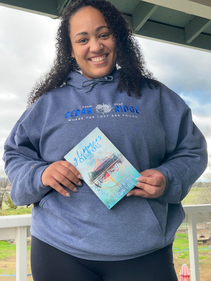a woman in a blue shirt holding a book