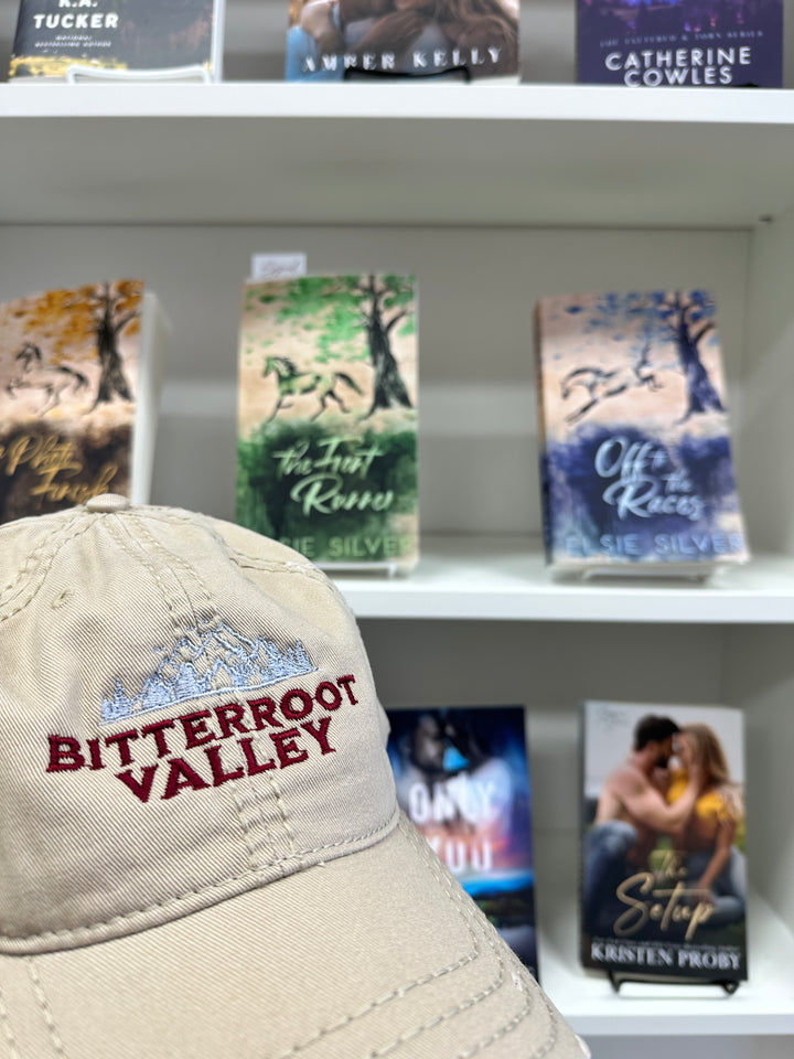 a hat is hanging on a book shelf
