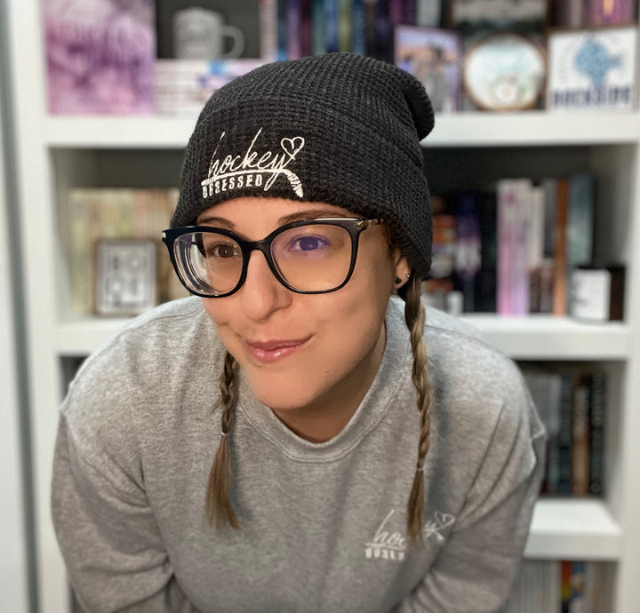 a woman with glasses and a hat on