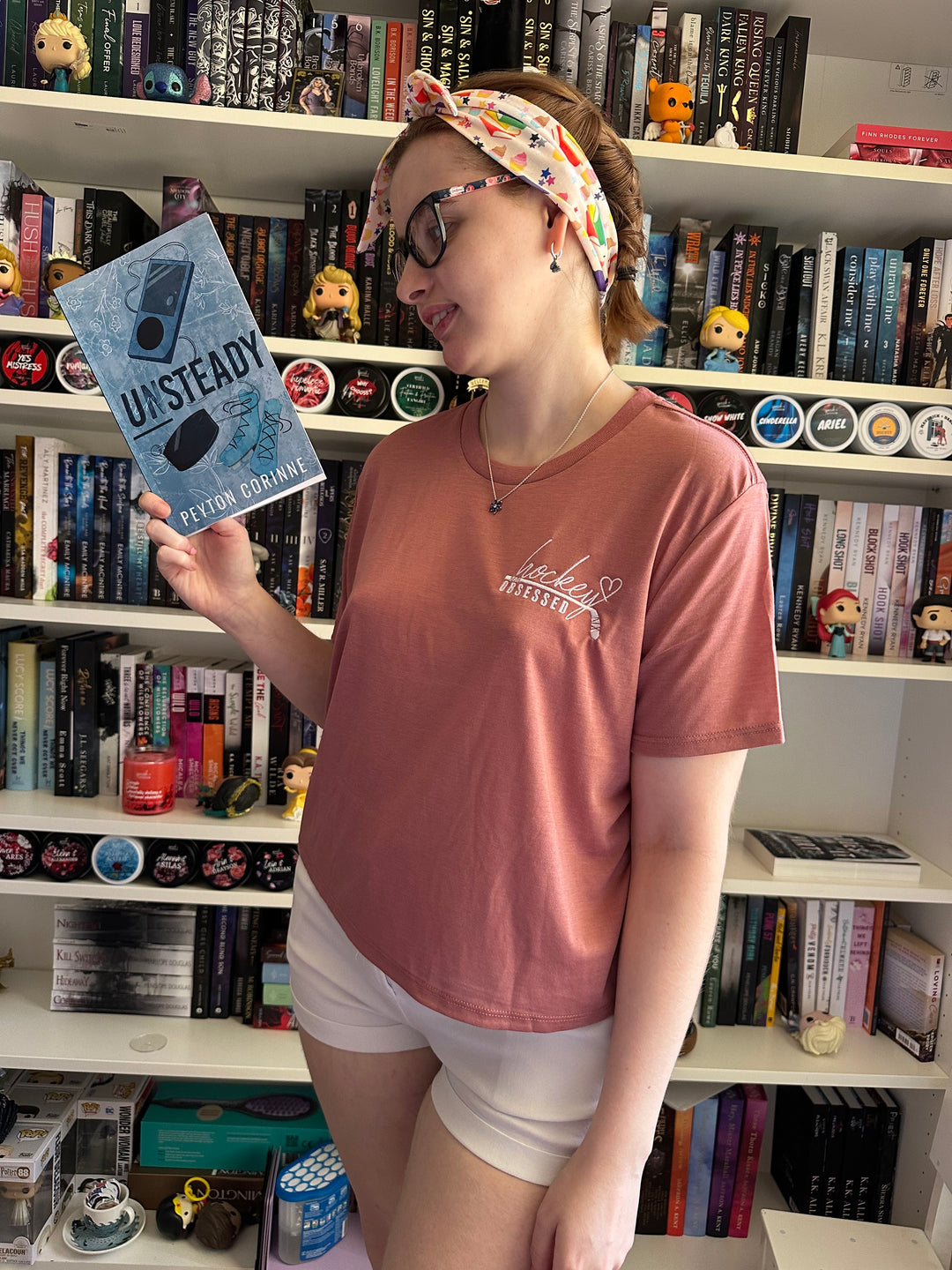a woman standing in front of a book shelf