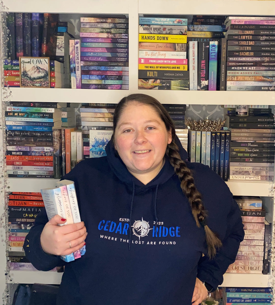 a woman standing in front of a book shelf