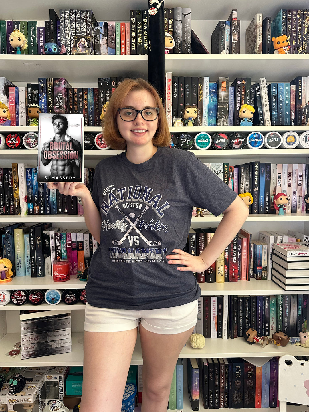 a woman standing in front of a book shelf