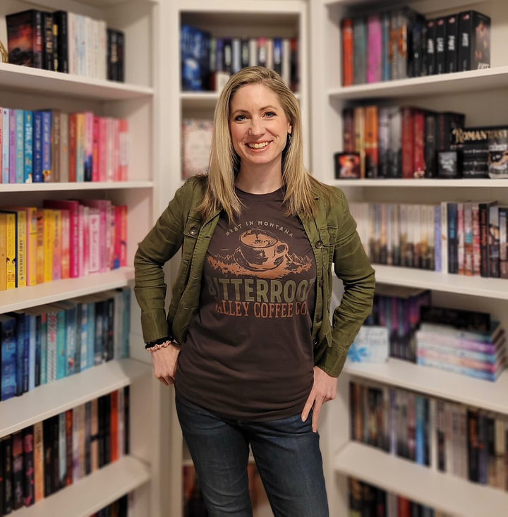 a woman standing in front of a book shelf