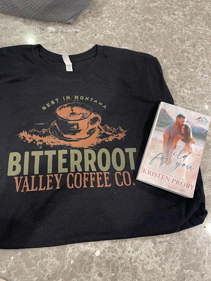 a t - shirt and a book on a table