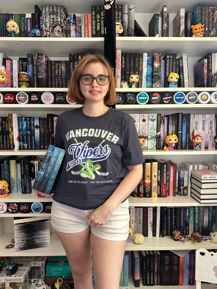 a woman standing in front of a book shelf filled with books