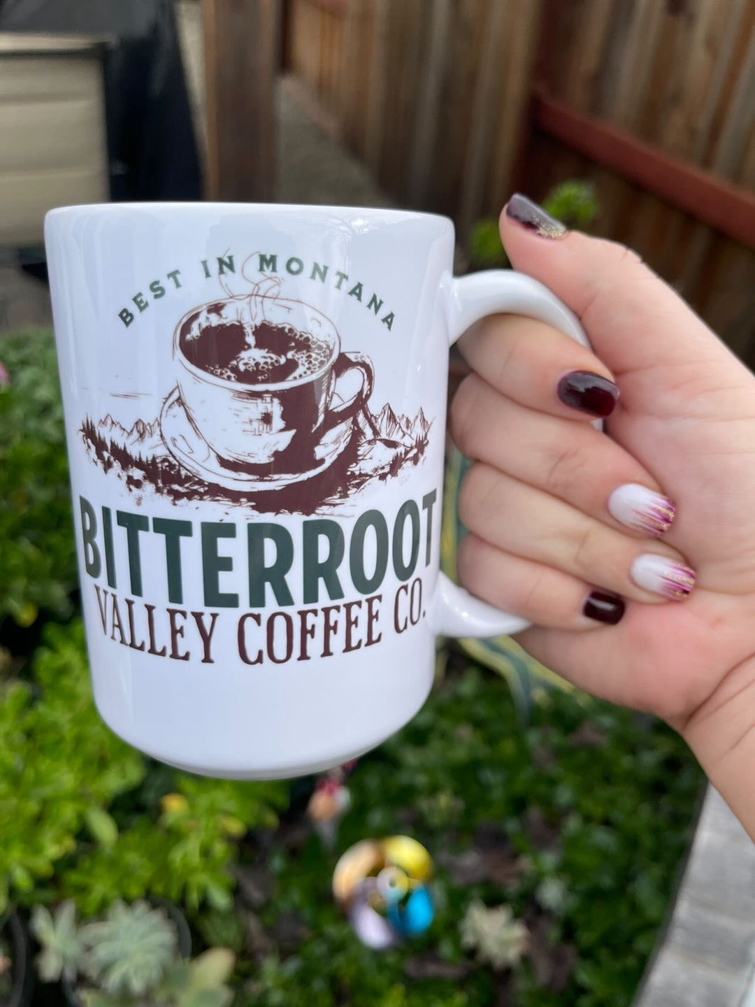 a woman holding a coffee mug in her hand