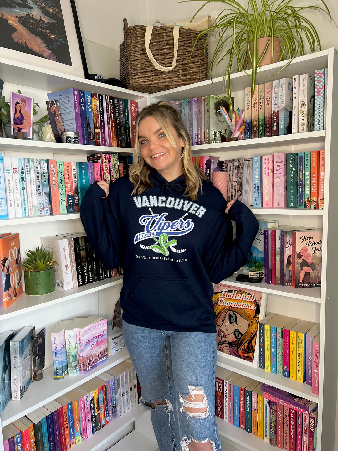 a woman standing in front of a bookshelf full of books