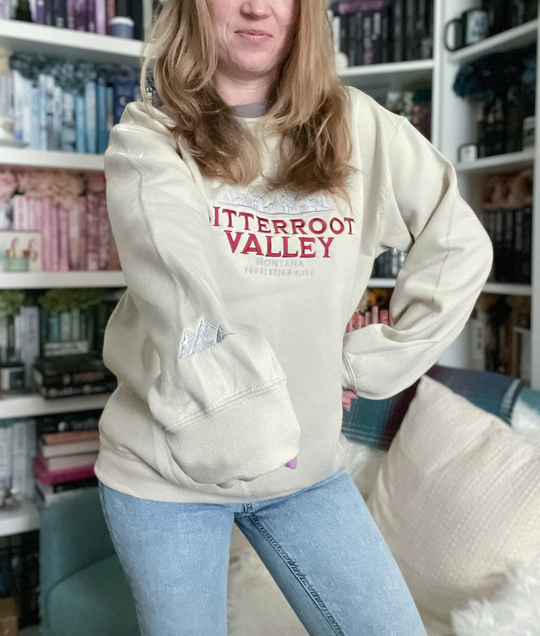 a woman standing in front of a book shelf