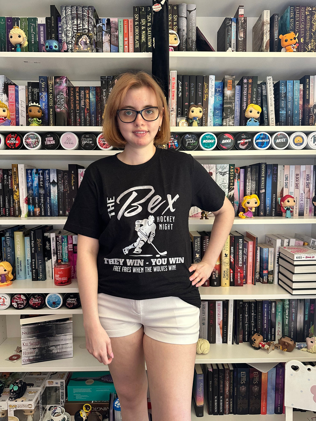 a woman standing in front of a book shelf