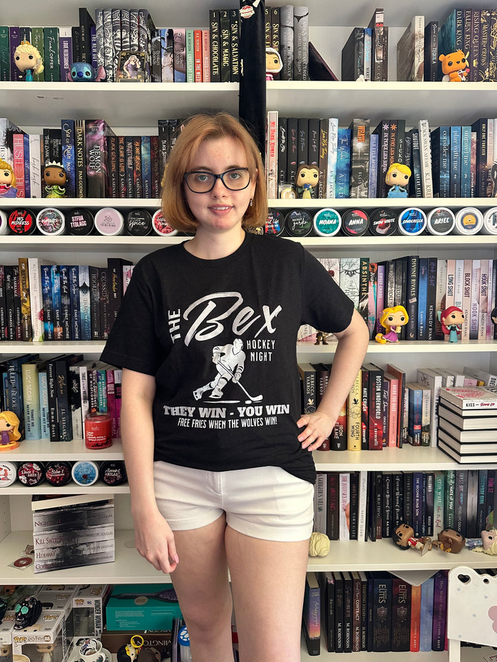 a woman standing in front of a book shelf