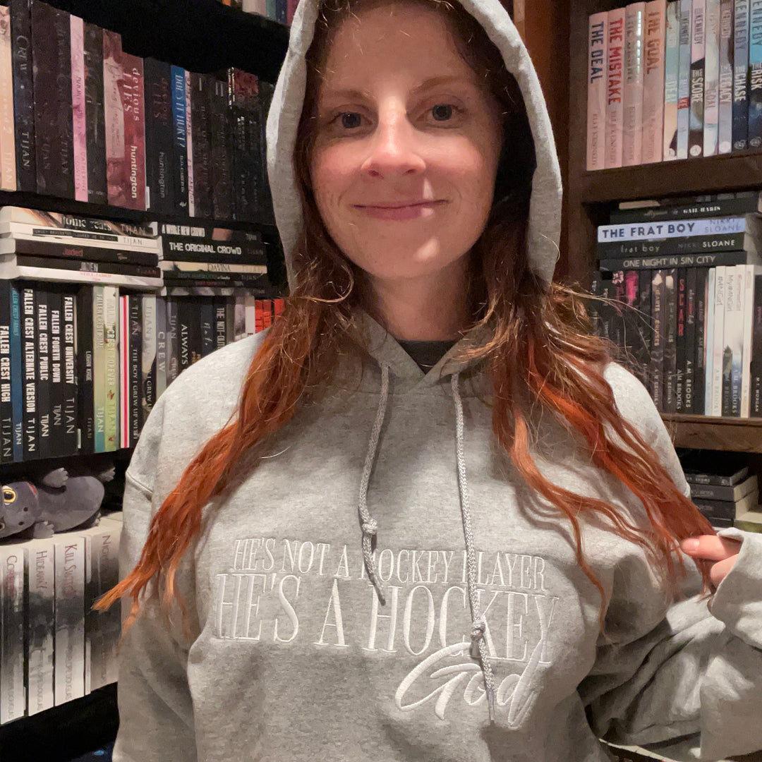 a woman standing in front of a book shelf