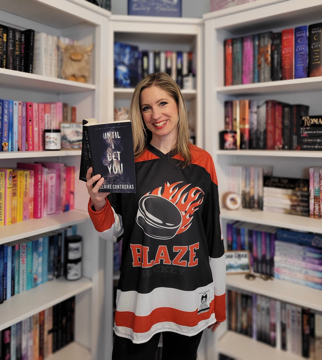 a woman holding a book in a library