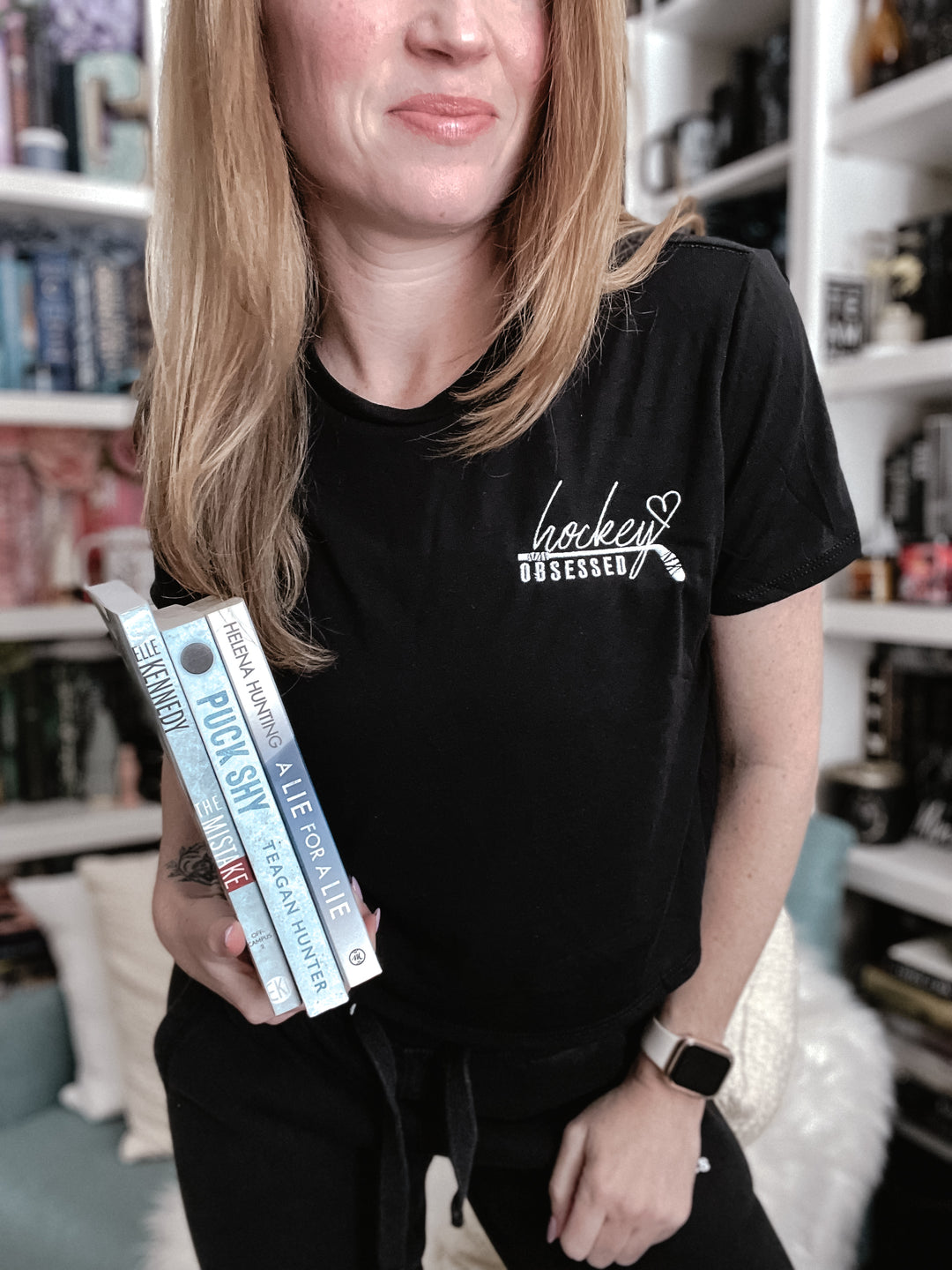 a woman holding a package of toothpaste in her hand