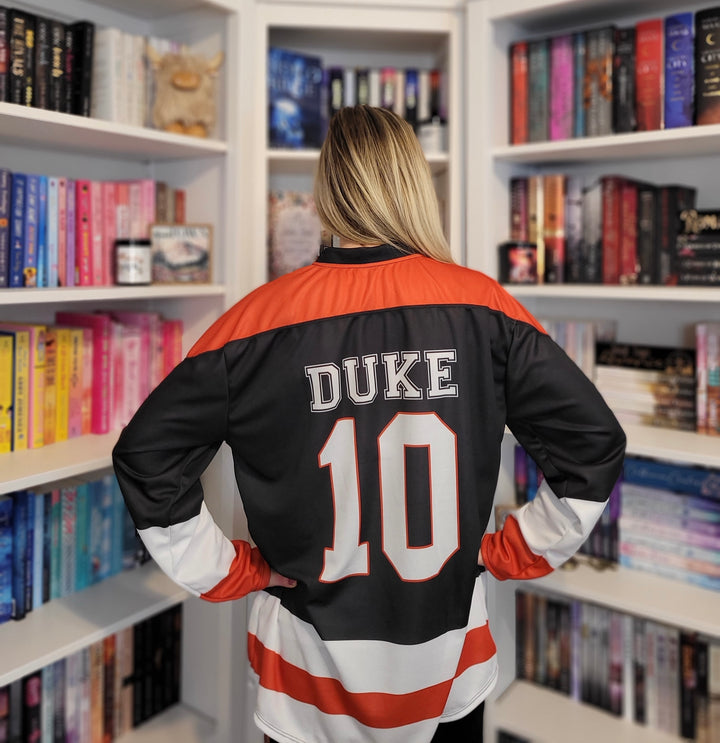 a woman standing in front of a book shelf