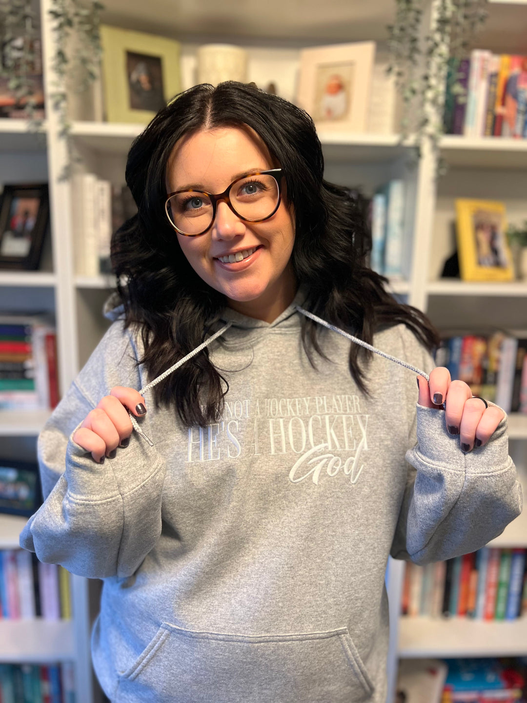 a woman holding a pair of scissors in front of her face