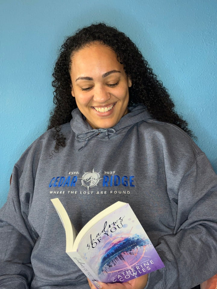 a woman is smiling while holding a book