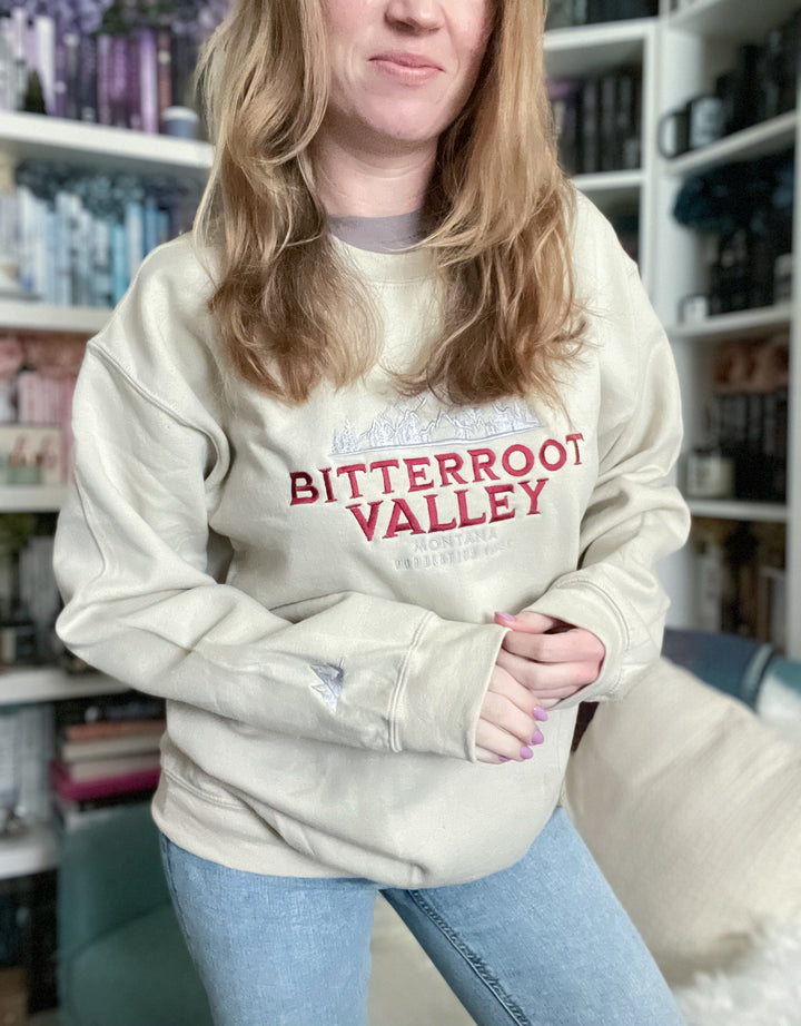 a woman standing in front of a book shelf