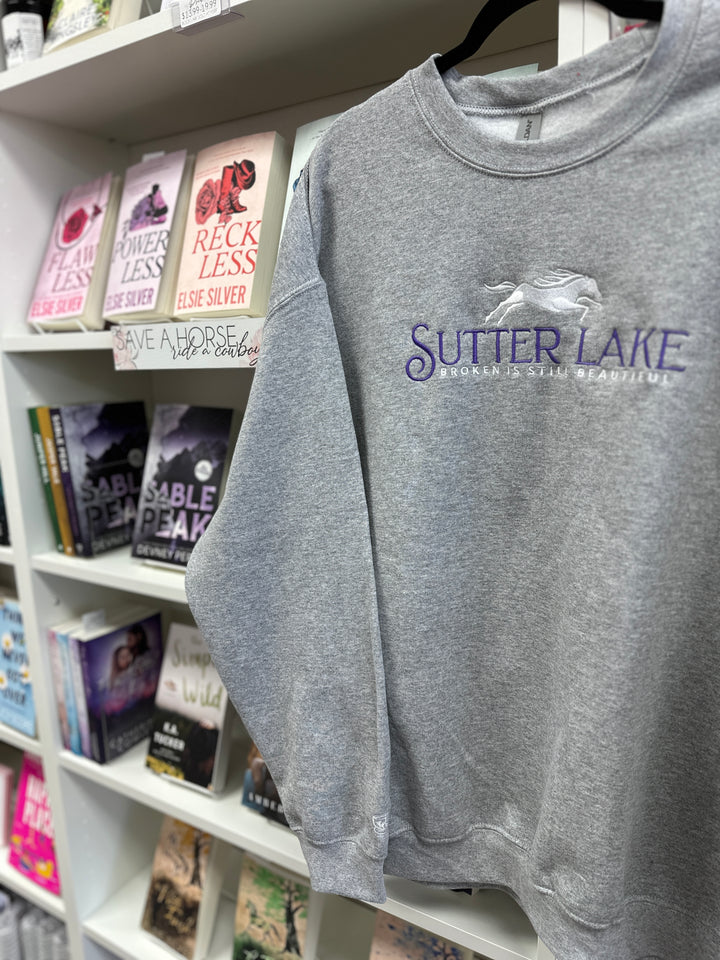 a t - shirt hanging on a book shelf in a bookstore