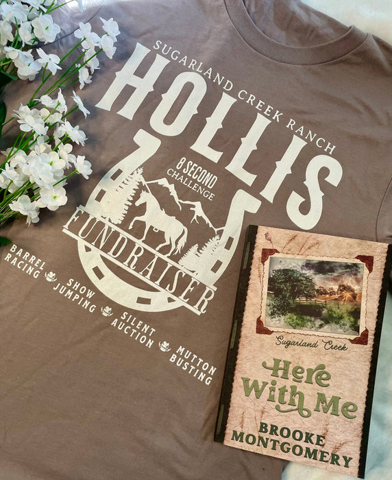 a brown t - shirt with a picture of mountains and trees on it