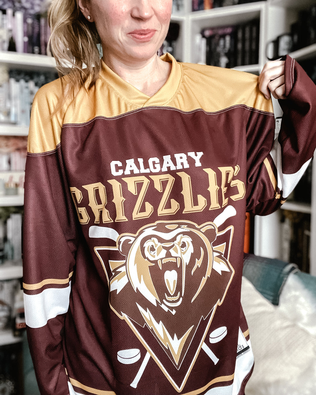 a woman in a brown and gold hockey jersey