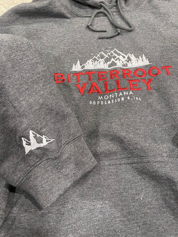 a gray sweatshirt with a red and white logo on it