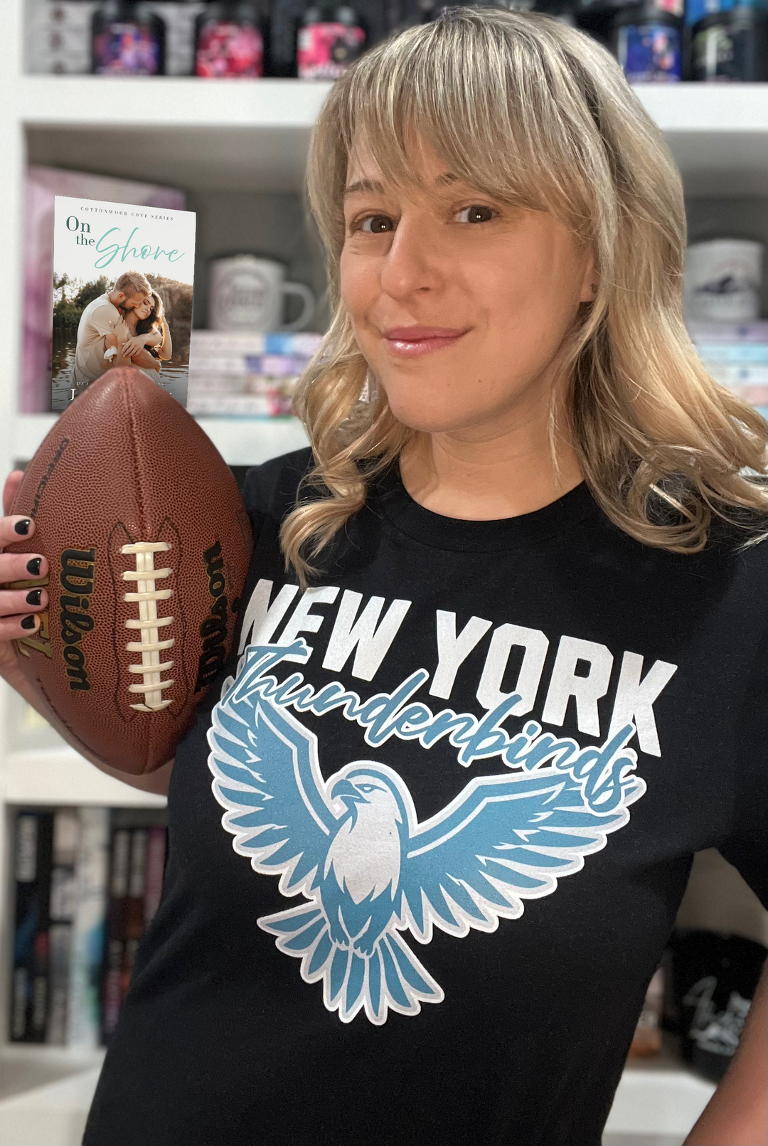 a woman holding a football and a card