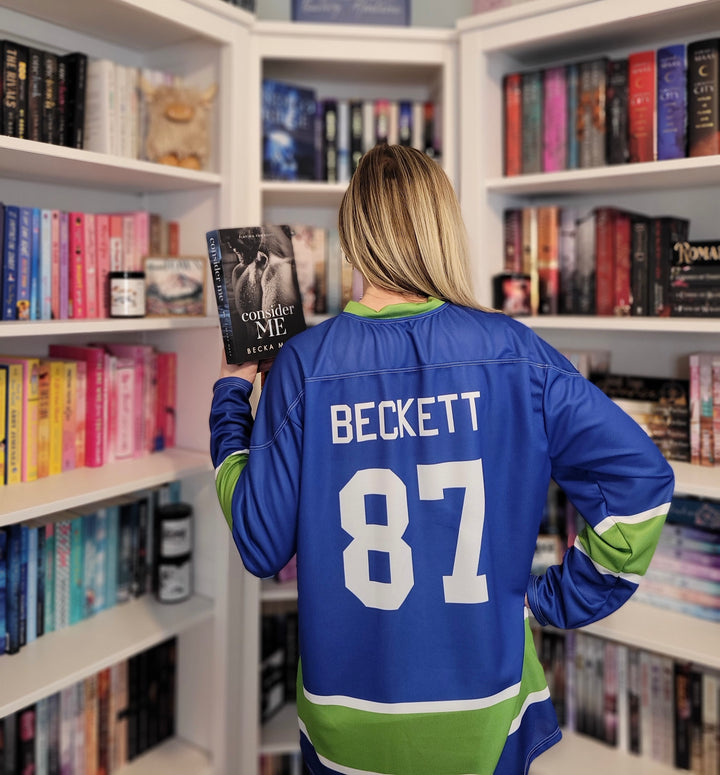 a woman in a hockey jersey reading a book