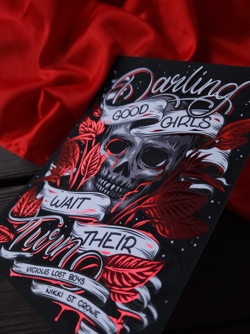 a black and red graduation cap with a skull on it