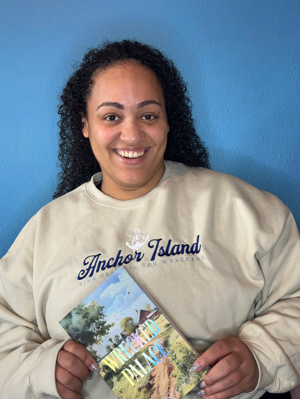 a woman is smiling while holding a book