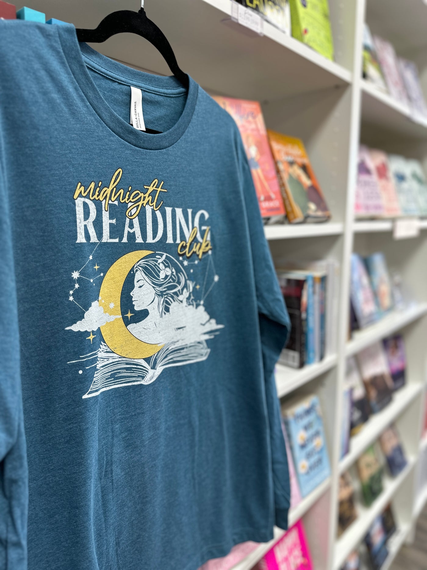a t - shirt with a picture of a woman reading a book